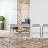 Chaises pliantes TUDELA BASIC grises en PVC dans un environnement de bureau moderne de hjh OFFICE