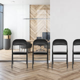 Quatre chaises pliantes TUDELA H noires avec revêtement en similicuir alignées de hjh OFFICE
